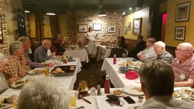 Members gathered around tables at a club event